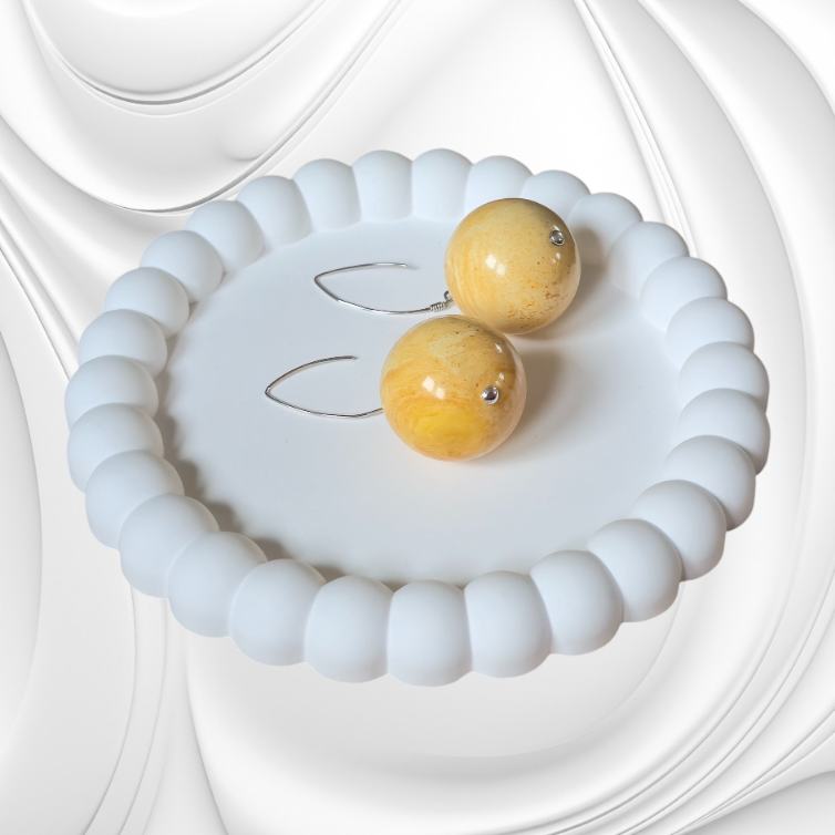 Kolczyki z dużą kulką mlecznego bursztynu na srebrnym zapięciu typu rybka