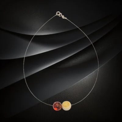 Naszyjnik z dwiema wypolerowanymi kulkami bursztynu bałtyckiego w odcieniu mlecznym i koniakowym